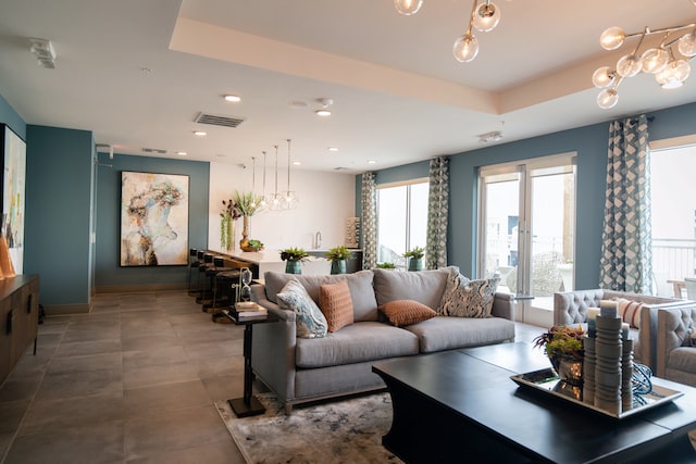 open concept living and dining room with blue and white walls, dark brown flooring and large picture windows
